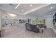 Open-concept living room featuring neutral tones, hardwood floors, a modern ceiling fan, and sliding glass doors to the lanai at 14227 County Road 455, Clermont, FL 34711
