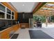 Outdoor kitchen with stainless steel appliances and a covered patio area at 14227 County Road 455, Clermont, FL 34711