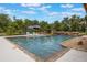 Spacious pool with rock waterfall feature, accompanied by lounge chairs, offering a relaxing outdoor experience at 14227 County Road 455, Clermont, FL 34711
