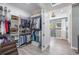 Large walk-in closet with custom shelving and a view into the tiled shower at 14227 County Road 455, Clermont, FL 34711
