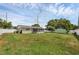 Exterior side view of home's backyard showing white fence, utility shed and covered porch at 1491 Providence Blvd, Deltona, FL 32725