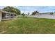 Expansive backyard featuring a screened-in porch and a large, well-maintained grassy area, perfect for outdoor activities at 1491 Providence Blvd, Deltona, FL 32725