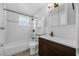 Clean bathroom with tiled shower and floors, modern vanity, and medicine cabinet at 1491 Providence Blvd, Deltona, FL 32725