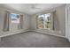 Cozy bedroom featuring neutral carpet, ceiling fan and two windows, providing ample natural light at 1491 Providence Blvd, Deltona, FL 32725