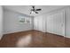 Bright bedroom with hardwood floors, a ceiling fan, and ample closet space at 1491 Providence Blvd, Deltona, FL 32725
