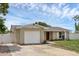 Charming single-story home featuring an attached one-car garage and beautiful landscaping at 1491 Providence Blvd, Deltona, FL 32725