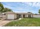 Charming single-story home featuring a well-manicured lawn, a light post and an attached one car garage at 1491 Providence Blvd, Deltona, FL 32725