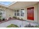Front porch of a charming home with a red door and landscaping at 1491 Providence Blvd, Deltona, FL 32725