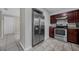 Bright kitchen view featuring stainless steel refrigerator and oven with tiled floors at 1491 Providence Blvd, Deltona, FL 32725