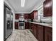Spacious kitchen featuring stainless steel appliances and ample dark wood cabinetry at 1491 Providence Blvd, Deltona, FL 32725