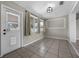 Cozy sunroom with bright light, tiled floor, and an exterior door at 1491 Providence Blvd, Deltona, FL 32725