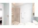 Bright bathroom featuring a glass-enclosed shower with a built-in niche and neutral color palette at 1496 Lime Grove Ln, The Villages, FL 32162