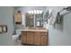 Bathroom featuring a wooden vanity with marble countertop, a toilet and a mirror at 1496 Lime Grove Ln, The Villages, FL 32162