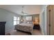 Bedroom with ceiling fan, shutters, and two end tables with lamps at 1496 Lime Grove Ln, The Villages, FL 32162