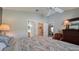 Bedroom with ceiling fan and a view to the ensuite bathroom, closet and sitting room at 1496 Lime Grove Ln, The Villages, FL 32162