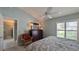Bedroom featuring a ceiling fan, shuttered window, dresser and decorative chair at 1496 Lime Grove Ln, The Villages, FL 32162