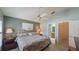 Bedroom with ceiling fan, shutters, and access to an ensuite bathroom and closet at 1496 Lime Grove Ln, The Villages, FL 32162
