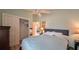 Bedroom with light green walls, ceiling fan, and closet with open door at 1496 Lime Grove Ln, The Villages, FL 32162