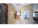 Inviting foyer leading to a bright kitchen and dining area, showcasing an open layout at 1496 Lime Grove Ln, The Villages, FL 32162