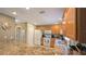 Bright kitchen features a skylight, granite countertops, and stainless steel appliances at 1496 Lime Grove Ln, The Villages, FL 32162