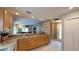Open-concept kitchen offering granite countertops and connection to the living area at 1496 Lime Grove Ln, The Villages, FL 32162