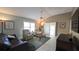 Bright living room featuring tile floors, comfortable seating, and sliding glass doors at 1496 Lime Grove Ln, The Villages, FL 32162