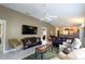Spacious living room with tile floors, comfortable seating, and a ceiling fan at 1496 Lime Grove Ln, The Villages, FL 32162