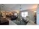 Open-concept living room with tile floors, comfortable seating, and a view of the kitchen at 1496 Lime Grove Ln, The Villages, FL 32162