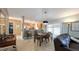 Open-concept living and dining area with a view of the kitchen and sliding glass doors at 1496 Lime Grove Ln, The Villages, FL 32162