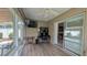 Cozy sunroom featuring tile flooring, desk area, and a sliding glass door leading to the home's interior at 1496 Lime Grove Ln, The Villages, FL 32162