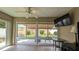 Bright sunroom with large windows overlooking the landscaped backyard and patio area at 1496 Lime Grove Ln, The Villages, FL 32162