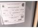 Image of the water heater label showing the model, serial number and manufacture date at 1496 Lime Grove Ln, The Villages, FL 32162