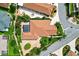 Overhead view of the property displaying mature landscaping, the outdoor pool area, and nearby street access at 1509 Trenton Ln, The Villages, FL 32162