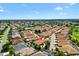 Aerial view of a home with well-maintained landscaping located in a peaceful residential community at 1509 Trenton Ln, The Villages, FL 32162