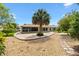 Spacious backyard with a stone patio and privacy landscaping offers a serene outdoor living space at 1509 Trenton Ln, The Villages, FL 32162