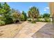 Beautifully landscaped backyard features lush greenery, decorative rock, and a stone-paved patio at 1509 Trenton Ln, The Villages, FL 32162