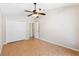 Neutral bedroom features tile flooring, double door closet, and natural lighting at 1509 Trenton Ln, The Villages, FL 32162