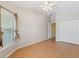 Bright bedroom with tile flooring, closet and a window with a view of greenery at 1509 Trenton Ln, The Villages, FL 32162