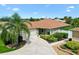 Charming single-story home with a well-manicured lawn, mature landscaping, and a spacious driveway at 1509 Trenton Ln, The Villages, FL 32162