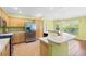Kitchen boasts stainless steel appliances, a breakfast bar, and ample wooden cabinet storage at 1509 Trenton Ln, The Villages, FL 32162