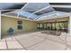 A covered patio features a hot tub, ceiling fans, and convenient access to the home's interior at 1509 Trenton Ln, The Villages, FL 32162