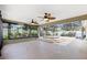Spacious screened in patio with dual ceiling fans, offering an ideal space for relaxing outdoors at 1509 Trenton Ln, The Villages, FL 32162
