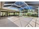 Covered lanai area with a hot tub, offering privacy and a relaxing outdoor living space at 1509 Trenton Ln, The Villages, FL 32162