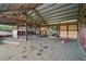 Open barn structure with a sand floor, wooden posts, and a corrugated metal roof provides ample shelter and workspace at 15104 County Road 48, Astatula, FL 34705