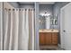 Bathroom featuring a vanity with mirror, framed art, and a shower with patterned curtain at 15104 County Road 48, Astatula, FL 34705