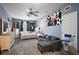Bedroom with grey walls, a ceiling fan, a sofa, and carpeted flooring at 15104 County Road 48, Astatula, FL 34705