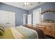 Bright bedroom with wood floors and a comfortable-sized closet at 15104 County Road 48, Astatula, FL 34705
