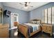 Comfortable bedroom with wooden furniture, a ceiling fan, and an ensuite bathroom at 15104 County Road 48, Astatula, FL 34705