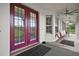 Inviting covered front porch with double doors, ceiling fans, and comfortable seating at 15104 County Road 48, Astatula, FL 34705