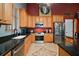 Well-equipped kitchen with stainless steel appliances, wood cabinets, and granite countertops at 15104 County Road 48, Astatula, FL 34705